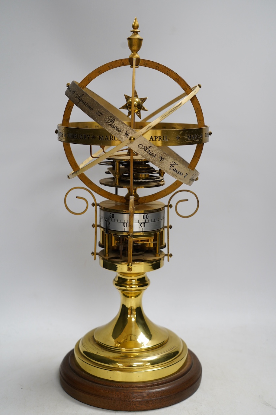 A modern clockwork armillary sphere, engraved St. James’s House Co. London, 44cm high, with two related books. Condition - fair, some discolouration to the metal work and general wear.